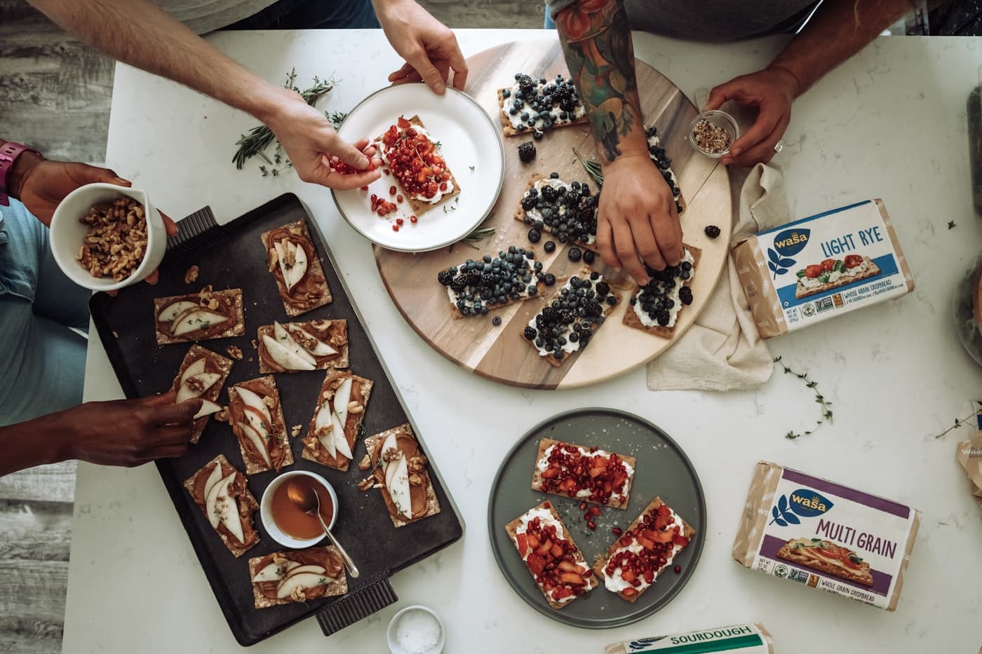 People preparing food together around a shared table